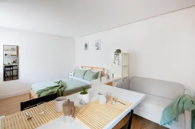 a room with a bed and a table and a bed at NOH Vatican Studio in Rome