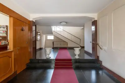 a hallway with a red carpet on the floor at NOH Vatican Studio in Rome