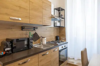 a small kitchen with a sink and a microwave at Vaticano Domvs - Appartamento ai Musei Vaticani in Rome