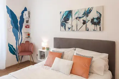 a bedroom with a bed with orange and white pillows at Vaticano Domvs - Appartamento ai Musei Vaticani in Rome