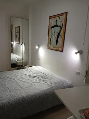 a white bedroom with a bed and a mirror at Guest House San Pietro in Rome