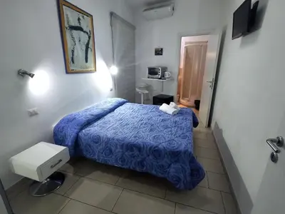 a bedroom with a blue bed in a room at Guest House San Pietro in Rome
