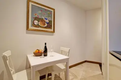 a dining room with a white table and a painting at SirtHouse in Rome