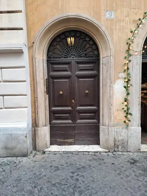 a large wooden door in a building at Home Piazza Dell'Orologio in Rome