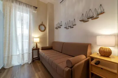 a living room with a couch and a window at CS Vatican Metro Apartment in Rome
