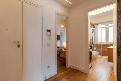 a hallway with a door leading to a living room at CS Vatican Metro Apartment in Rome