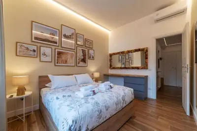 a bedroom with a bed and a mirror on the wall at CS Vatican Metro Apartment in Rome