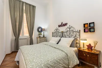a bedroom with a large bed and a window at Delizioso appartamento a Roma in posizione strategica in Rome