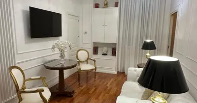 a living room with a white couch and a table at Alloggio turistico King Plaza in Rome