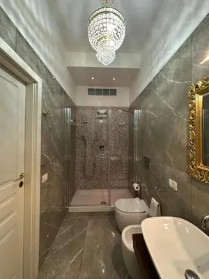 a bathroom with a shower and a toilet and a sink at Alloggio turistico King Plaza in Rome
