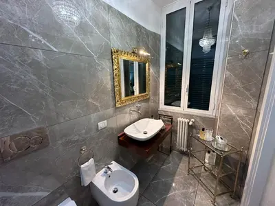 a bathroom with a sink and a toilet at Alloggio turistico King Plaza in Rome