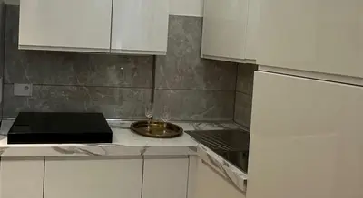 a kitchen with white cabinets and a bowl on the counter at Alloggio turistico King Plaza in Rome