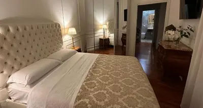 a bedroom with a large bed with a white bedspread at Alloggio turistico King Plaza in Rome