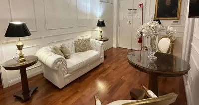 a living room with a white couch and a glass table at Alloggio turistico King Plaza in Rome