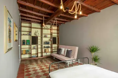 a bedroom with a bed and a couch in a room at Dimora Florea - in the heart of Campo de' Fiori in Rome