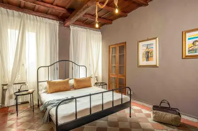 a bedroom with a bed and a large window at Dimora Florea - in the heart of Campo de' Fiori in Rome