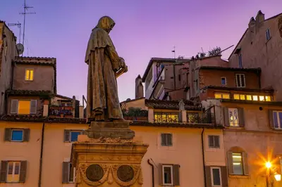 a statue of a man standing in front of a building at Dimora Florea - in the heart of Campo de' Fiori in Rome