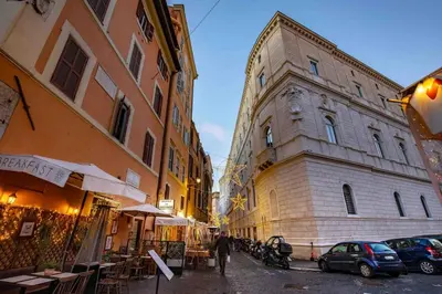 a man walking down a street next to buildings at Dimora Florea - in the heart of Campo de' Fiori in Rome