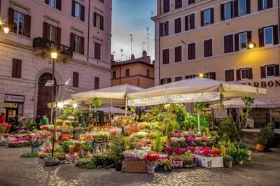 an outdoor flower market with flowers and umbrellas at Dimora Florea - in the heart of Campo de' Fiori in Rome