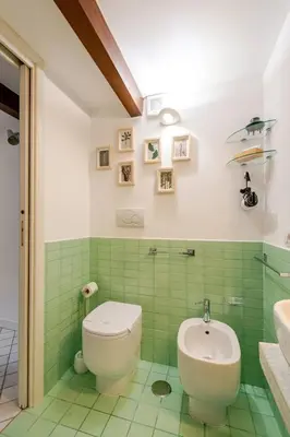 a bathroom with a toilet and a sink at Cottage San Giovanni in Rome