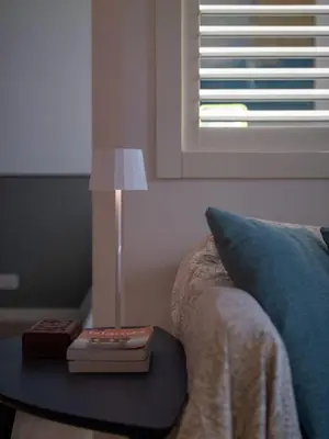 a lamp on a table next to a bed at Luxury Penthouse Parioli in Rome