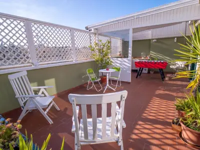a balcony with two chairs and a table and chairs at Luxury Penthouse Parioli in Rome