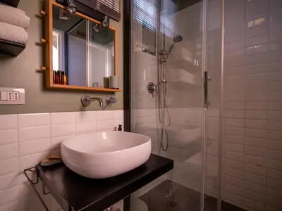 a bathroom with a sink and a glass shower at Luxury Penthouse Parioli in Rome