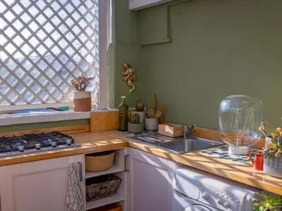 a kitchen with a counter with a sink and a stove at Luxury Penthouse Parioli in Rome