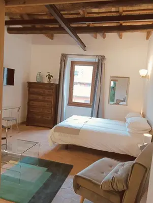 a bedroom with a large bed and a window at luxury suites Trastevere in Rome