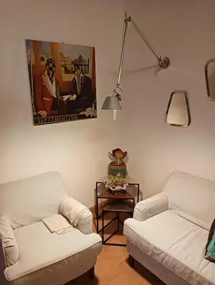 a living room with two white couches and a table at luxury suites Trastevere in Rome