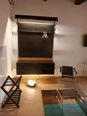 a living room with a large screen and a chair at luxury suites Trastevere in Rome