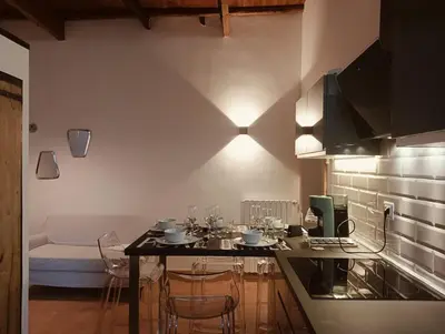 a kitchen with a table and chairs in a kitchen at luxury suites Trastevere in Rome