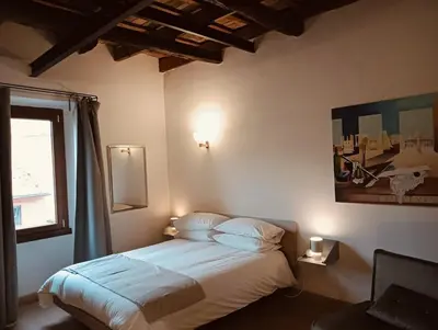 a bedroom with a bed and a window at luxury suites Trastevere in Rome