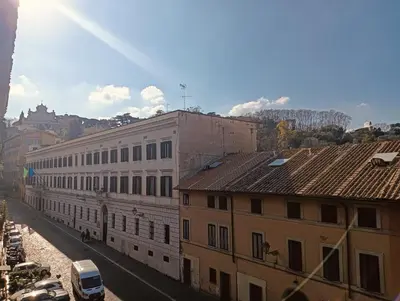 a city street with buildings and a mountain in the background at luxury suites Trastevere in Rome