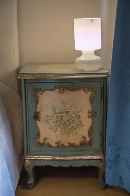 a end table with a lamp on top of it at Campo Marzio Charming in Rome