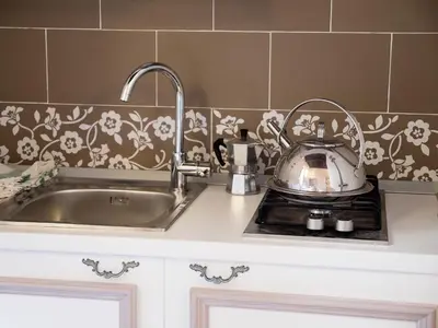 a kitchen counter with a sink and a tea kettle at Campo Marzio Charming in Rome