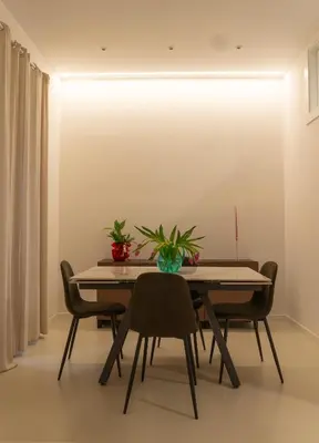 a dining room with a table and chairs at Il Cortile del 900 in Rome