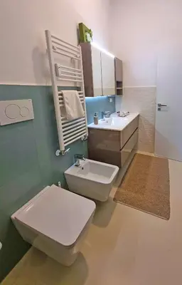 a bathroom with a white toilet and a sink at Il Cortile del 900 in Rome