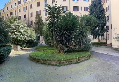 a palm tree in front of a building at Il Cortile del 900 in Rome