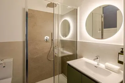 a bathroom with a shower and a sink and a mirror at Design Apt Moderno Pzz del Popolo - Parking in Rome