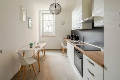 a kitchen with a table and a counter top at Design Apt Moderno Pzz del Popolo - Parking in Rome
