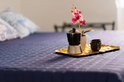 a table with a plate with a flower on it at Mami Apartment in Rome