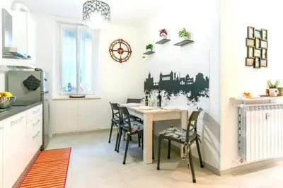 a kitchen and dining room with a table and chairs at Mami Apartment in Rome