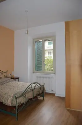 a bedroom with a bed and a window at Il regno dei colori in Rome