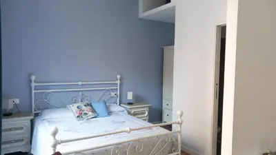 a blue bedroom with a white bed and blue walls at Il regno dei colori in Rome