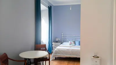a bedroom with a bed and a table and a table and chairs at Il regno dei colori in Rome
