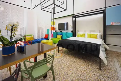 a bedroom with a bed and a table and chairs at GALAXY By ROMEI in Rome