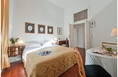 a bedroom with a large bed and a table at B&B Colori di Roma in Rome