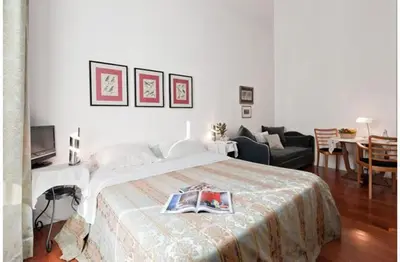 a bedroom with a bed and a living room at B&B Colori di Roma in Rome
