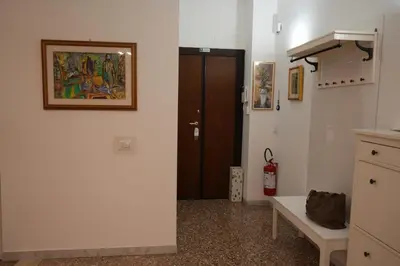 a room with a door and a bench and a table at Casa Giovanna in Rome